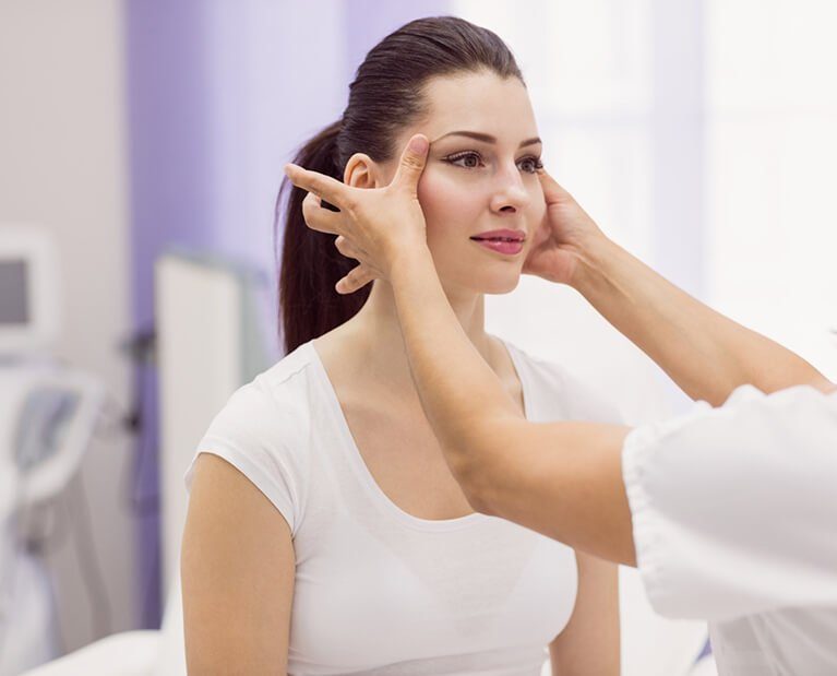 dermatologist-examining-female-patient-skin