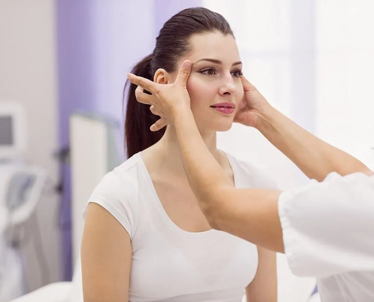 dermatologist-examining-female-patient-skin